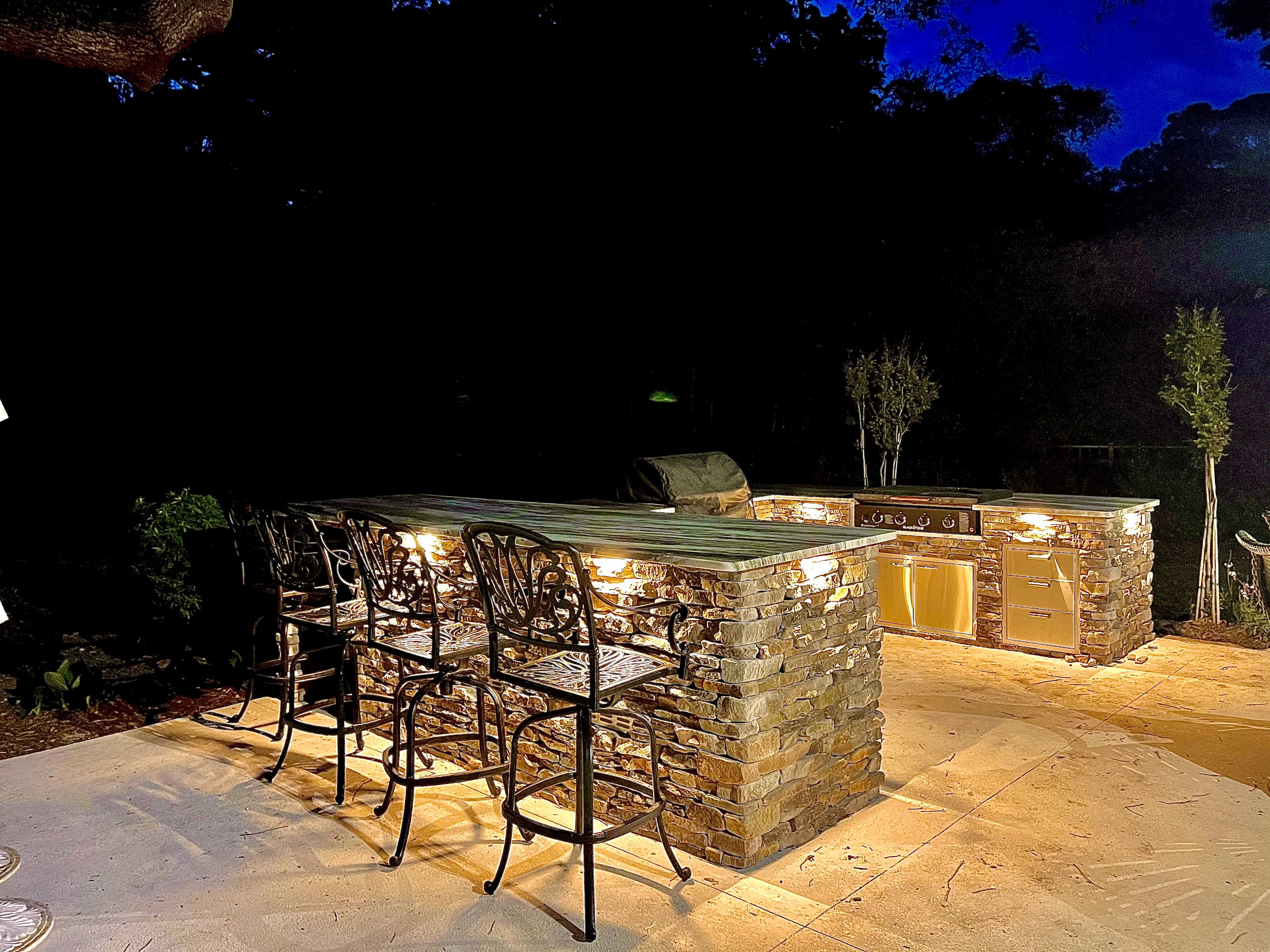 Custom outdoor kitchen with stone construction and lighting Hilton Head